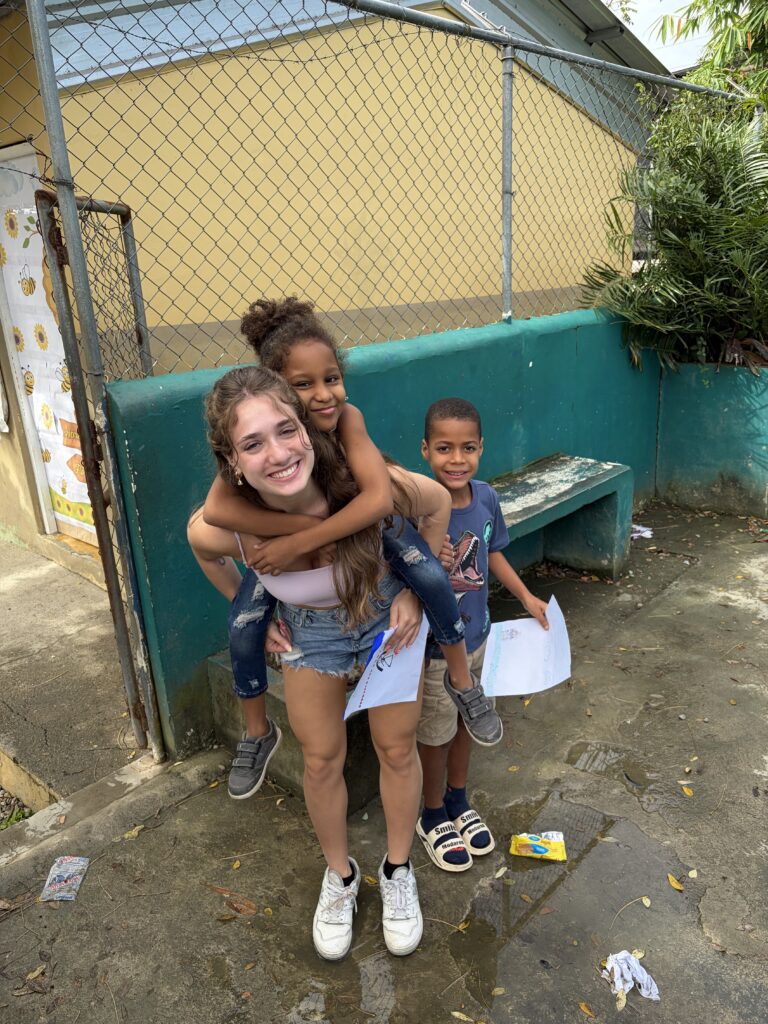 Student plays with children.